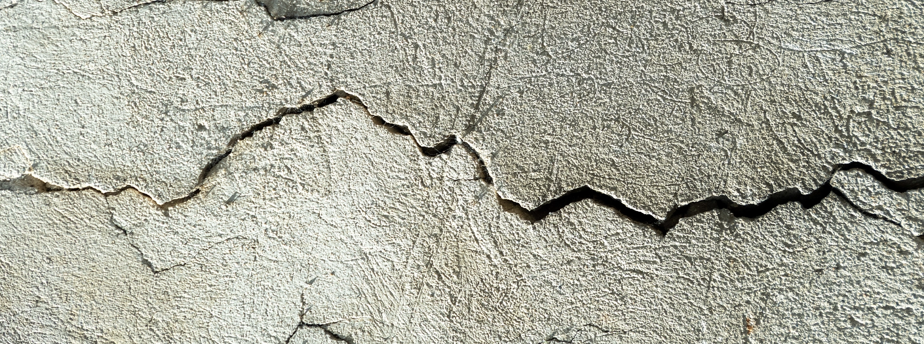 Residential foundation crack being evaluated by a structural engineer